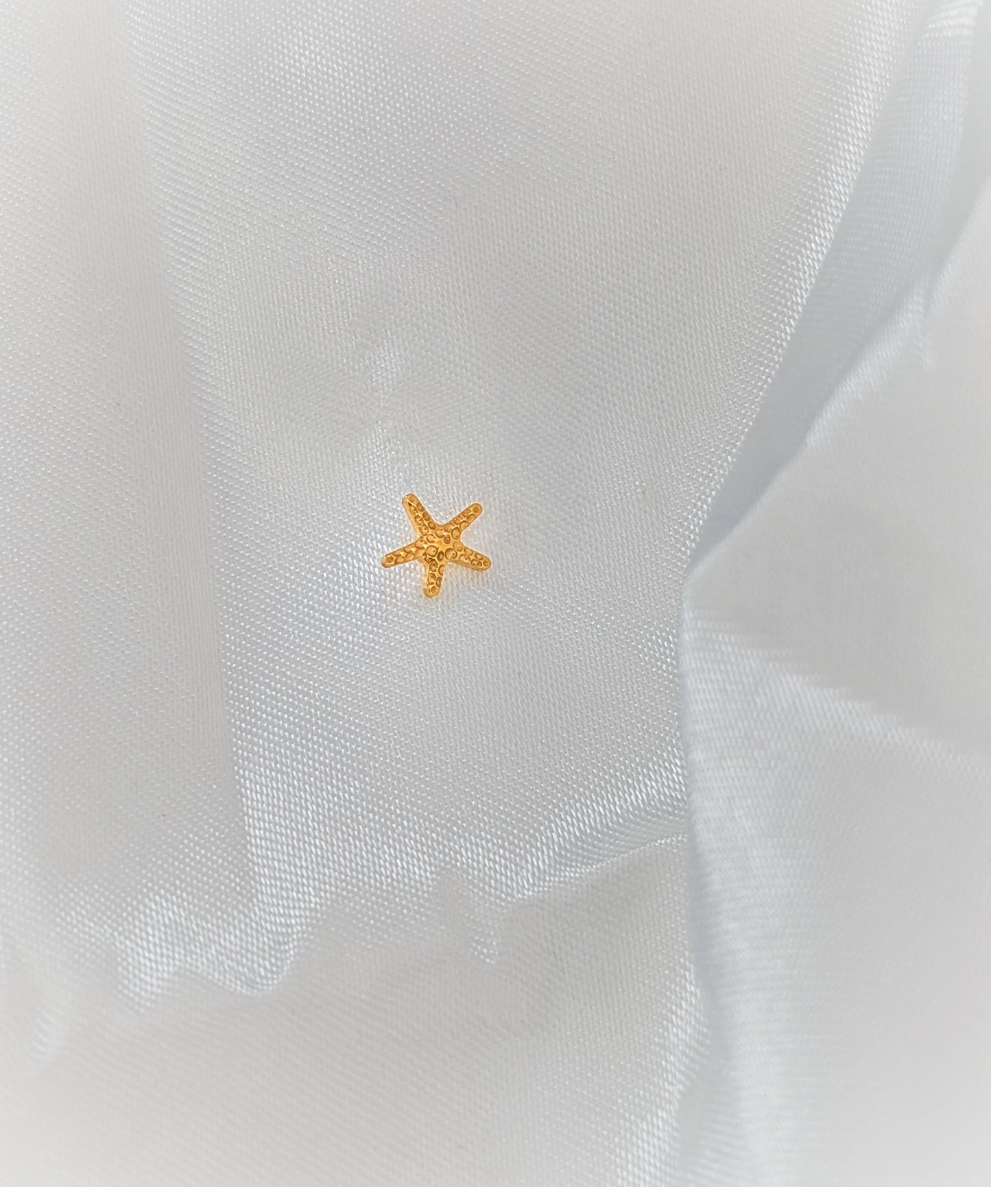 Golden Starfish Piercing – Bold, Ocean-Inspired Elegance